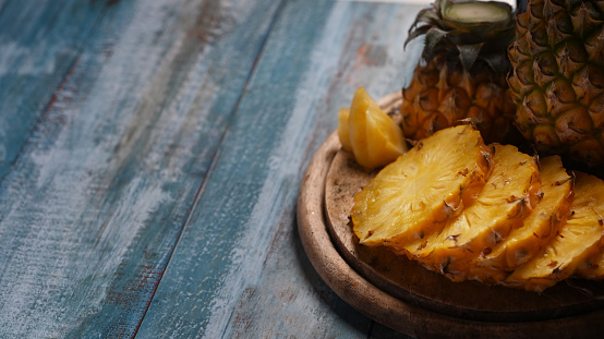 Pineapple slices on wooden background