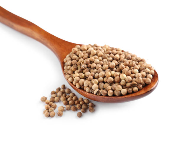 istock Dried coriander seeds with wooden spoon on white background 1398075849