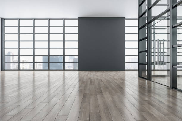 istock Bright exhibition interior with wooden parquet flooring, reflections, panoramic window frame and city view, daylight and mock up place on wall. Gallery and museum concept. 3D Rendering. 1398077415