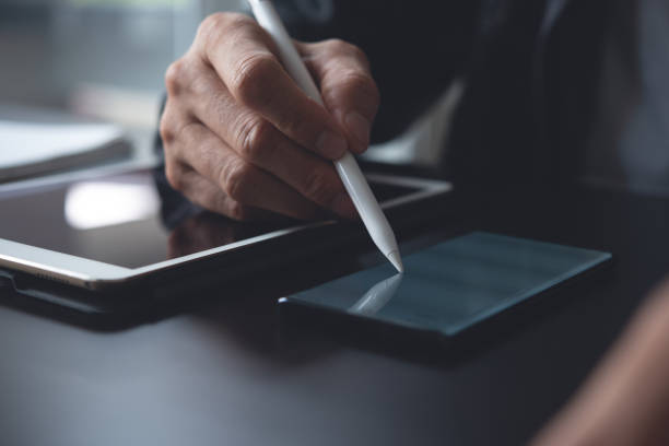 istock Business man using stylus pen on tablet 1398077566