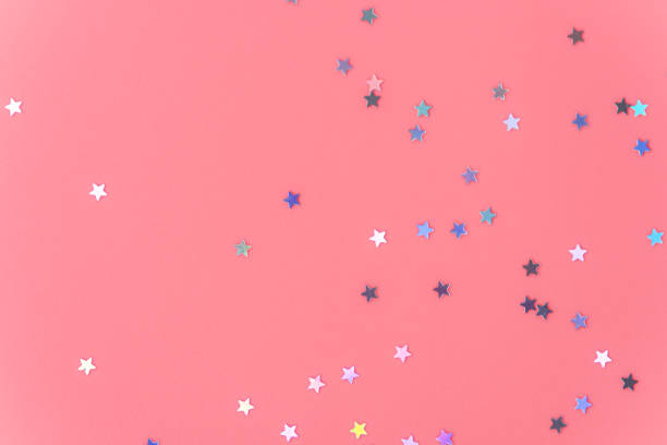 istock Silver stars glittering confetti on pink background. Trendy festive holiday backdrop 1398078253