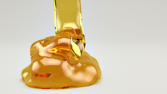 honey pouring on white background