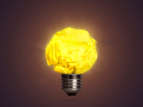 Good idea concept with shining yellow crumpled paper lightbulb. This file is cleaned and retouched.