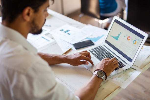 istock Successful businessman working in the office analyzing business data on notebook 1398078807