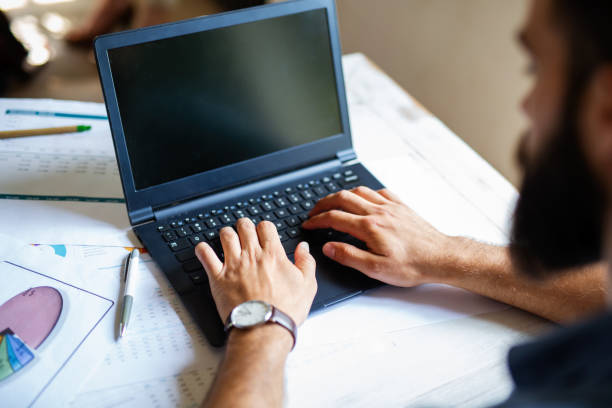 istock Successful businessman working in the office analyzing business data on notebook 1398078834
