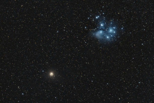 The Pleiades or Seven Sisters M45 meeting the planet mars on the night sky The Pleiades or Seven Sisters M45 meeting the planet mars on the night sky the pleiades stock pictures, royalty-free photos & images