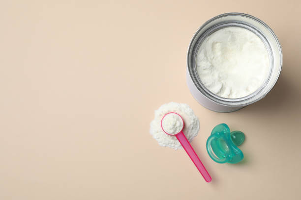 istock Flat lay composition with powdered infant formula on beige background, space for text. Baby milk 1398078960