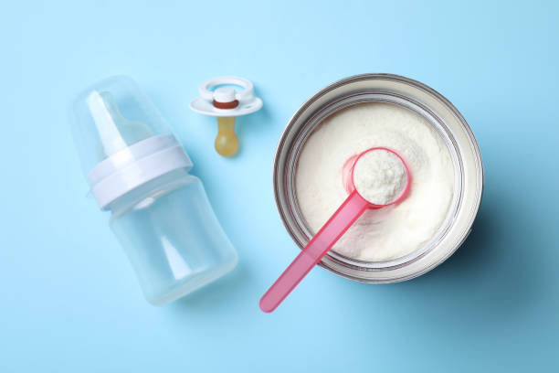 istock Flat lay composition with powdered infant formula on light blue background. Baby milk 1398080254