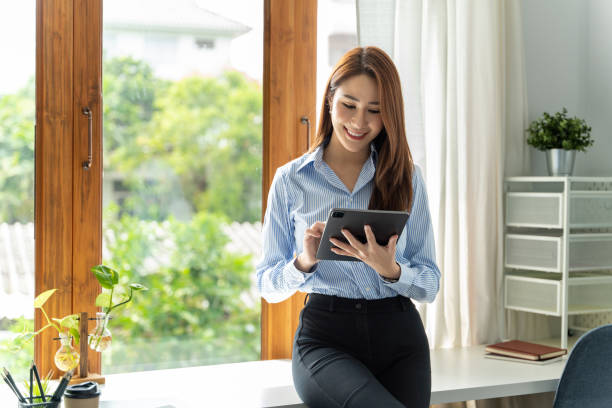istock Creative Asian young woman working on tablet in her studio. 1398080768