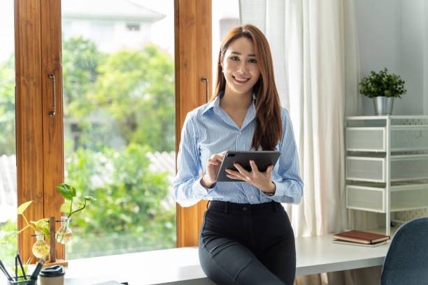 istock Creative Asian young woman working on tablet in her studio. 1398080789