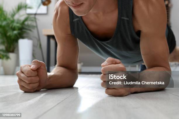 Man Doing Plank Exercise On Floor At Home Closeup Stock Photo - Download Image Now - Forearm, Men, Plank Position