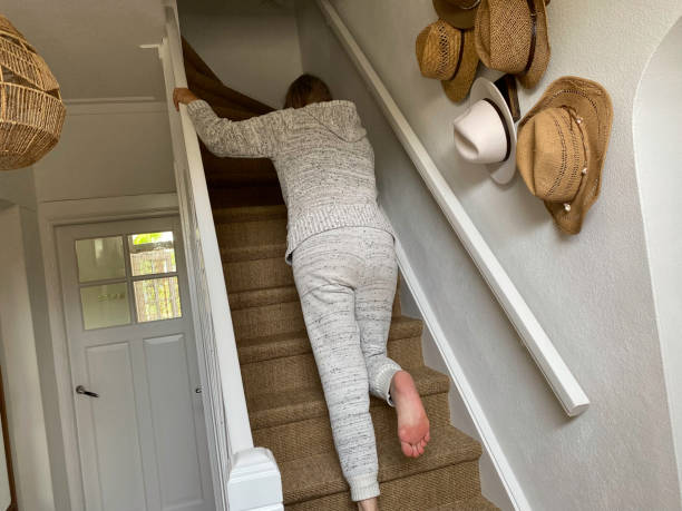istock Limping Woman with bruised foot on staircase 1398082127
