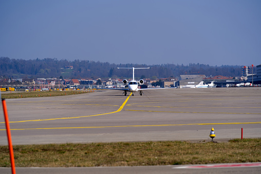 Netjets private airplane Embraer Phenom 300 register CS-PHR taxiing at Zürich Airport on a sunny spring day. Photo taken March 26th, 2022, Zurich, Switzerland.