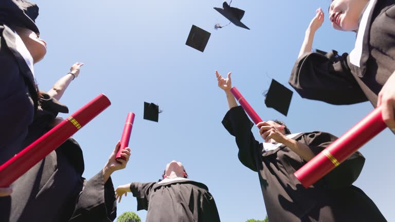 group happy graduates throw caps