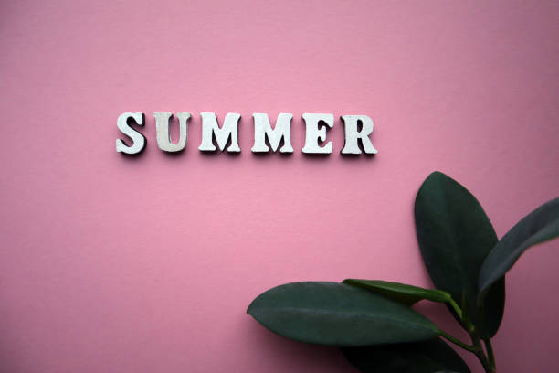 istock Summer concept. Wooden letters on pink background with copy space. 1398086229