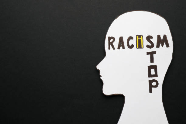 istock Human head cutout and phrase Stop Racism on black background, top view. Space for text 1398087082