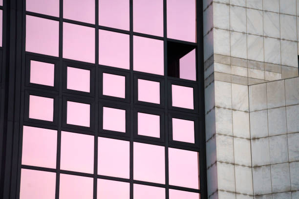 Nuuk, Godthåb, Greenland, Denmark - August 19th 2024:  Concrete facade of a residential building with a small antennae sticking out of the window and catching the sunligth