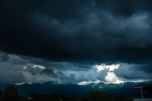 31st july 2021. Dehradun, Uttarakhand, India. A wide angle view of mussoorie hills from dehradun city with dark clouds and sun.