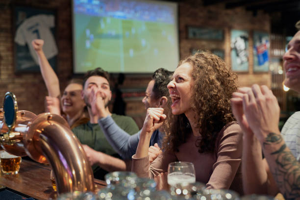 istock Happy Friends Watching Soccer Match At Bar 1398093067