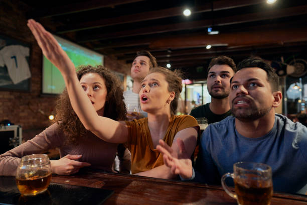 istock Happy Friends Watching Soccer Match At Bar 1398093103