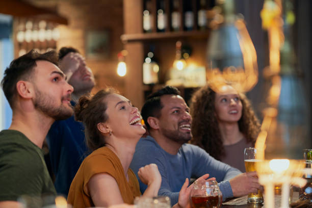 istock Happy Friends Watching Soccer Match At Bar 1398093178