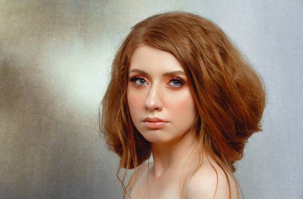 Side view Pretty red haired woman studio portrait.