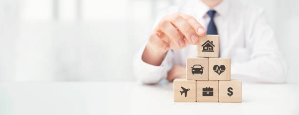 istock Insurance agent and blocks with insurance symbols 1398098492