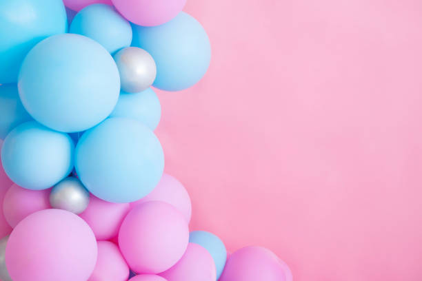 istock Blue and pink balloons on a pink background with copy space. 1398098990