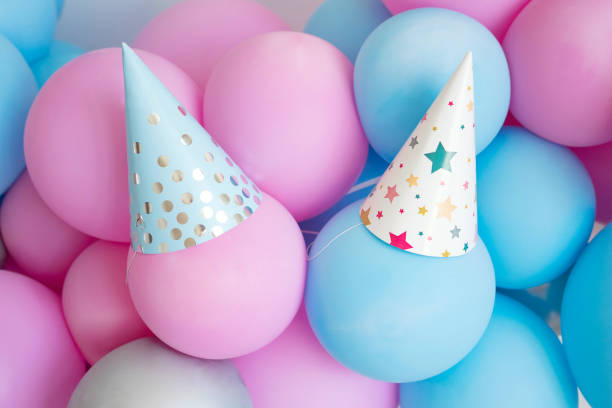 istock Party caps on Blue and pink balloons. 1398099025