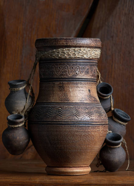 istock Earthenware jug standing on dark room 1398099586