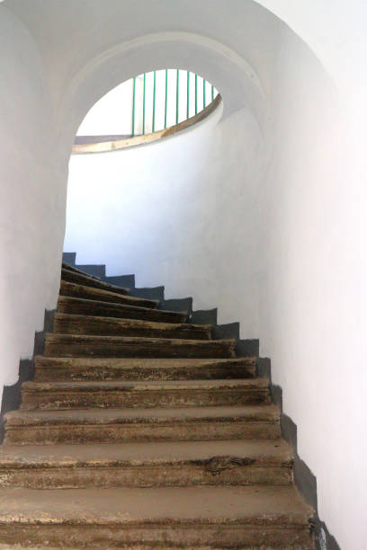 istock Old narrow medieval spiral stairs under arch 1398100479