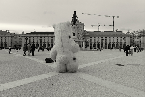 Lisbon, Portugal - Mars 13, 2022: A street artist performs as a ploar bear at the Praça do Comércio Square in Lisbon downtown.
