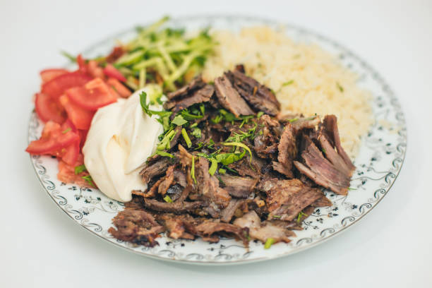 istock doner or shawarma called pilav ustu on rice, with yogurt , tomatoes and herbs 1398103492