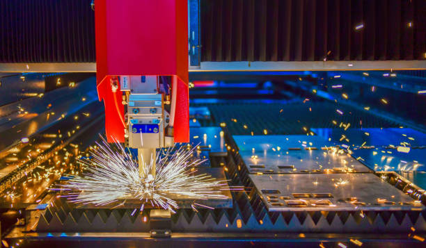 Industrial laser cut machine while cutting the sheet metal with the sparking light.