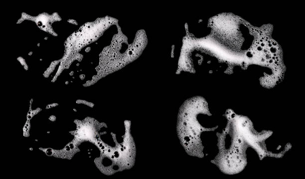 Top view, liquid white foam from soap or shampoo or shower gel. Top view, liquid white foam from soap or shampoo or shower gel. Abstract bubbles. isolated on a black background water on black surface stock pictures, royalty-free photos & images