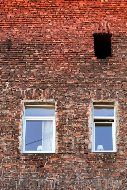 istock Old brick wall and new plastic windows. 1398106006