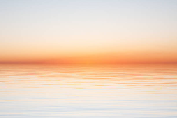 istock Clear morning sky over water surface with waves on blue sky 1398106317
