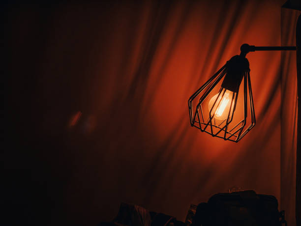 istock Edison's light bulb inside house closeup. Electric yellow lamps generating Light. Electricity glowing in the dark. Vintage decor Retro style 1398106684