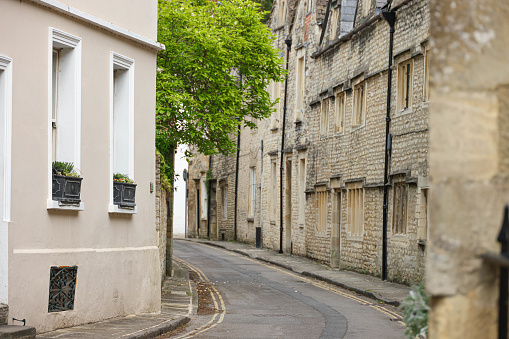 Quaint, cosy and secluded 17th century Cotswold street full of row/terraced houses  in The Cotswold town of Cirencester, Gloucestershire. England