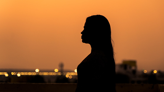 Silhouette of a woman during sunset or sunrise