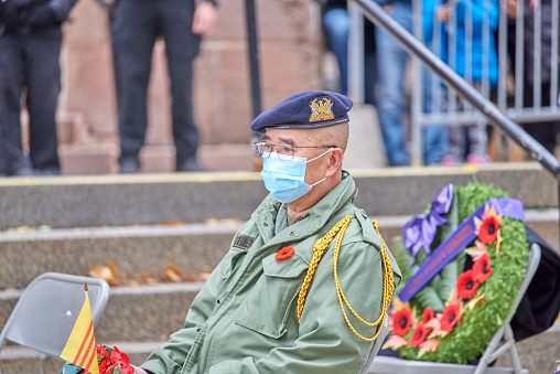 Toronto, Ontario, Canada- November, 11 2021: An Asian  Canadian Veteran  Wearing a mask to protect others from Covid-19 at the Remembrance day ceremony.