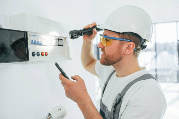 istock Electricity problems. Repairman is working indoors in the modern room 1398108172