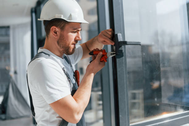 istock Using tool on the windows. Repairman is working indoors in the modern room 1398108760