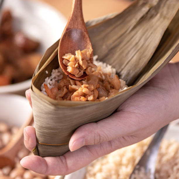 istock Making zongzi food - preparing and wrapping Chinese rice dumpling. 1398108798