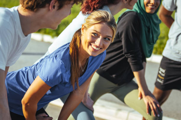istock Multiethnic group of young adults stretches together after running. 1398112671