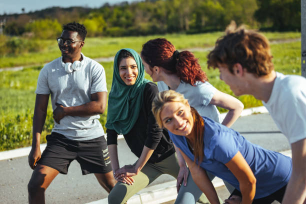 istock Group of multiethnic students laughing after running 1398112682