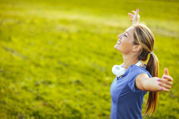 Woman with head back and arms outstretched