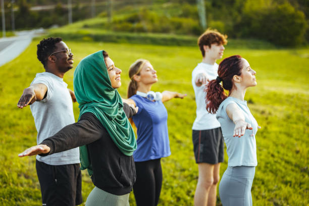 istock Friends standing with their arms outstretched. 1398114335