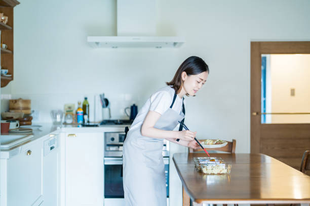 istock A woman cooking at kitchen 1398114345