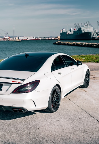 Long Beach, CA, USA\nJuly 10, 2021\nWhite Mercedes Benz CLS 63s AMG that is blacked out parked across from a navy ship.